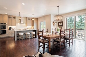 Spacious kitchen and dining area with hardwood flooring