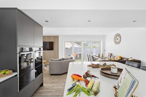 Spacious open-plan living area with curved sofas