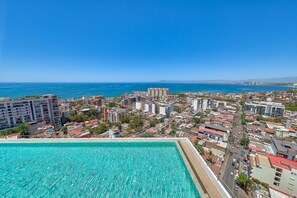 Infinity rooftop pool overlooking the city and ocean