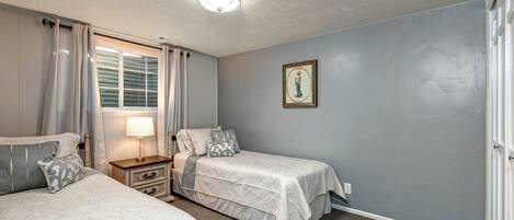 Cozy room with two twin beds and a view from the window.