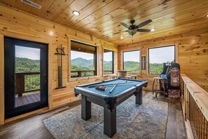 top deck access and game area with pool table and pac man machine