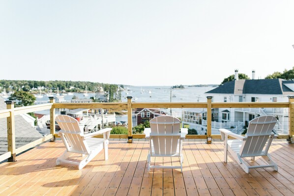 Relax on our rooftop deck with sweeping views of Boothbay Harbor. Unwind in Adirondack chairs, watch sailboats drift by, and enjoy the perfect perch for coastal sunsets—just steps from downtown at the historic Greenleaf Inn.