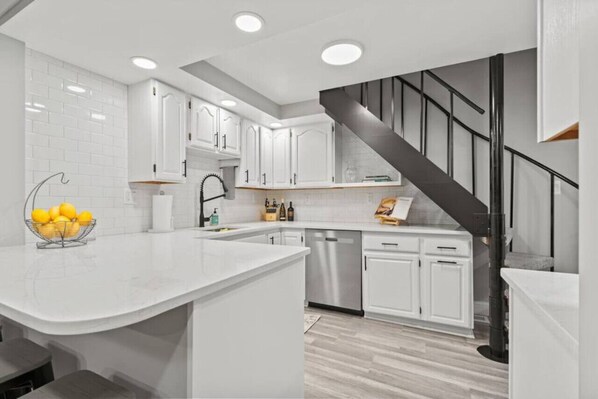 Enjoy cooking a meal together in this updated kitchen, complete with a gas stove and stainless steel appliances