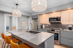 Full sized kitchen and island seating area.