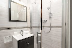 Bright bathroom with spacious shower.
