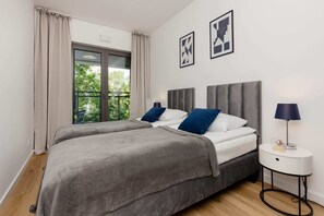 Cozy bedroom with 2 single beds and exit to balcony.