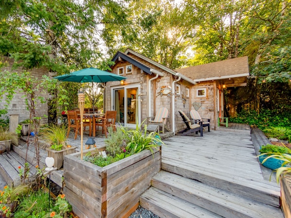 Front of home with large deck and seating area