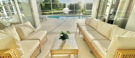 Patio furniture with spectacular pool, lake and sunset view.