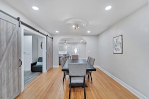 Dining Table with Barn doors to workspace/office area.