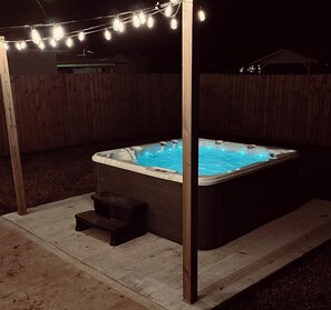 Completely private, 7 person Hot Tub in fully fenced backyard next to fireplace.