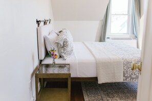 Enjoy coastal charm in Room 4, featuring a plush queen bed, soft linens, classic decor, and a sunny window view. A serene and stylish escape in the heart of Boothbay Harbor, Maine.