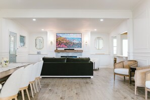 Relax in our beautifully updated shared living room featuring a cozy fireplace, large smart TV, elegant décor, and ample seating. Perfect for unwinding after exploring Boothbay Harbor's shops, dining, and waterfront attractions.