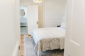 Room 5 at Greenleaf Inn features a queen bed, soft natural light, vintage charm, and a private ensuite bath—perfect for a relaxing Boothbay Harbor getaway in coastal Maine.