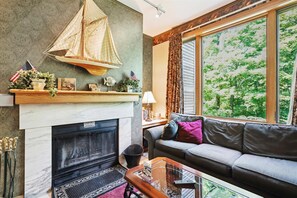 Tastefully decorated living room. Enjoy the warm glow from the wood burning fireplace.