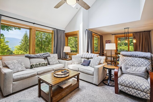 Open floor plan living room  beaming with natural light. Lots of seating available for your comfort.