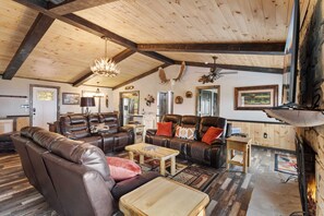 Spacious Living Room with Reclining Sofas and a Gas Fireplace