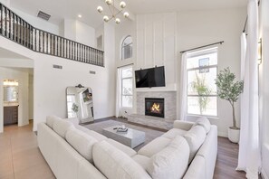 Family room with large sectional sofa, 65" Smart TV w/ Youtube TV Live & gas fireplace