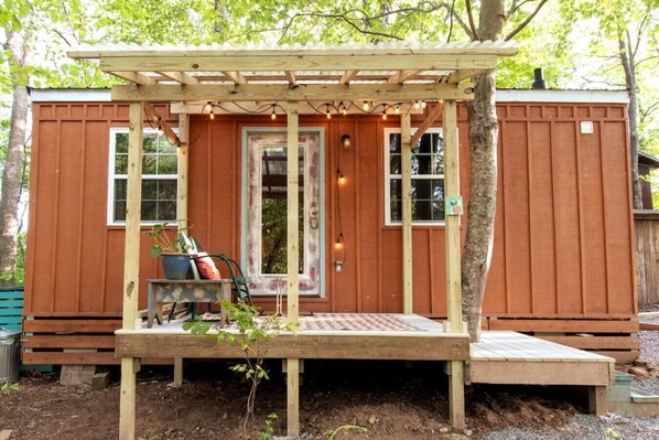 Unwind beneath the greenhouse porch roof to the sound of rainfall and the rustle of Dogwoods.