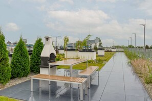 Elegant terrace with grill located in the common area.