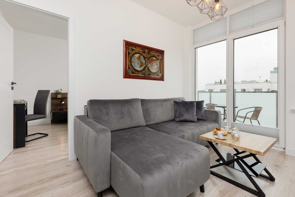 Relax in the stylish living room with a comfortable sofa and modern decor.