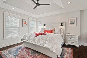 King Bedroom with Stylish tray ceiling, ceiling fan, tv, and office space
