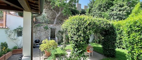 The garden with its several aromatic plants and the ancient city walls!