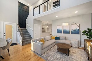 View from front door - high ceilings and TONS of natural sun light.  Newly remodeled and brand new furniture.  Hardwood floors, custom accented walls, and more for you to enjoy!