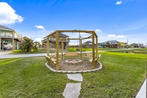 Outdoor firepit + swing area behind the house.