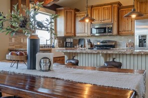 Cooking will be a delight in this beautifully appointed kitchen! The warm wood cabinetry, modern appliances, and ample counter space make meal prep a breeze. You will love the attention to detail and the inviting atmosphere for culinary adventures. (Full kitchen and large dining table)