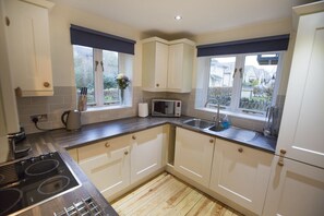 Kitchen with full size fridge freezer, dishwasher, washing machine, induction hob and oven