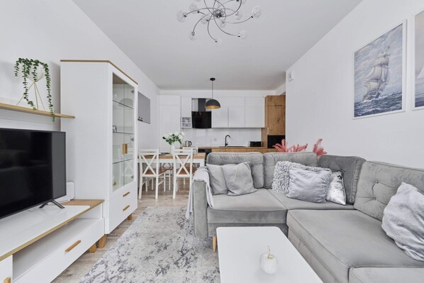 The elegant living room featuring a double sofa bed, perfect for relaxing or sleeping.