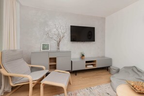 The living room's sleek design is both functional and aesthetically pleasing.