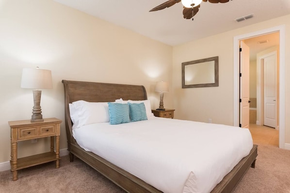 Unwind in this generously-sized bedroom with a luxurious king-sized bed and soothing decor. Sunlight and serenity pour in through the large window, enhancing the warm, inviting ambiance.