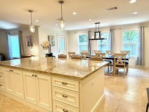 Kitchen and dining area with backyard view.