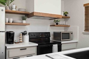 Stainless stove and oven / microwave, pots, and utensils available for your home-cooked meals.