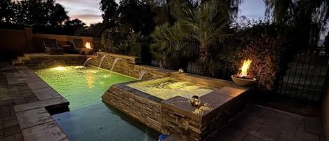 Impeccable dusk ambiance with a private pool and fire pits