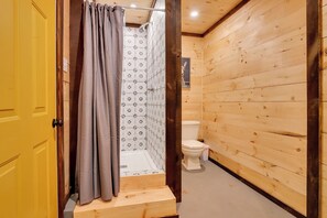 The bathhouse is a short walk from the glamping tents. The bathhouse includes a hot shower, toilet and sink.