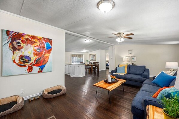 Cozy living room with beautiful pops of color, two sofas, and two dog beds!