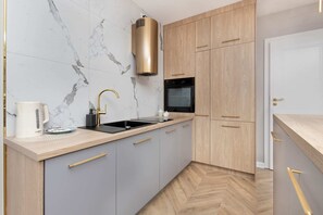 The sleek design of the kitchenette blending seamlessly with the living area.