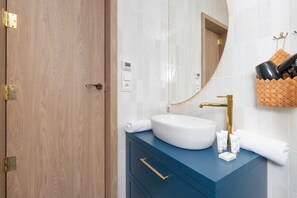 The bathroom offers a clean and functional space for your stay. 