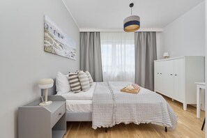 The cosy bedroom features a luxurious double bed and ample storage.