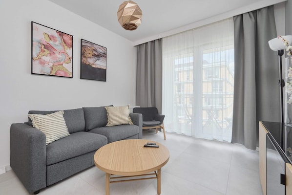 Relax in the stylish living room with a comfortable sofa and modern decor.