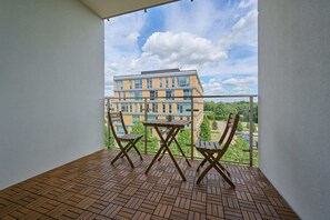 The balcony's stylish design complements the apartment's decor. 