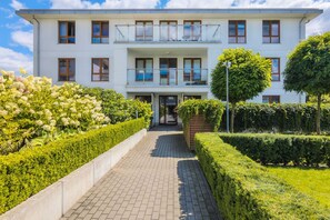 Well-maintained greenery and landscaped gardens surrounding the building, creating a peaceful and inviting atmosphere.