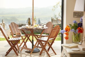 Lower ground floor: The garden room opens via bi-fold doors to the decked area with beautiful views of rolling countryside