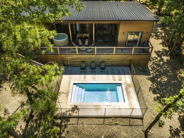 Outdoor Oasis: Splash into luxury with a heated pool amidst serene forest views!