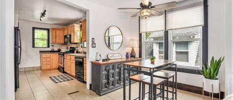 Charming Dining Area with Large Bright Windows and Beautiful Buffet