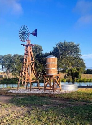 Decorative windmill with fountain and fish pond. 