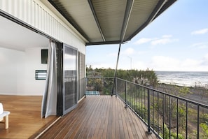 Wake to views across the water from the balcony adjoining the primary and second bedrooms upstairs.
