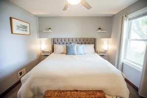 King bedroom with exra seating area and walk in closet.
